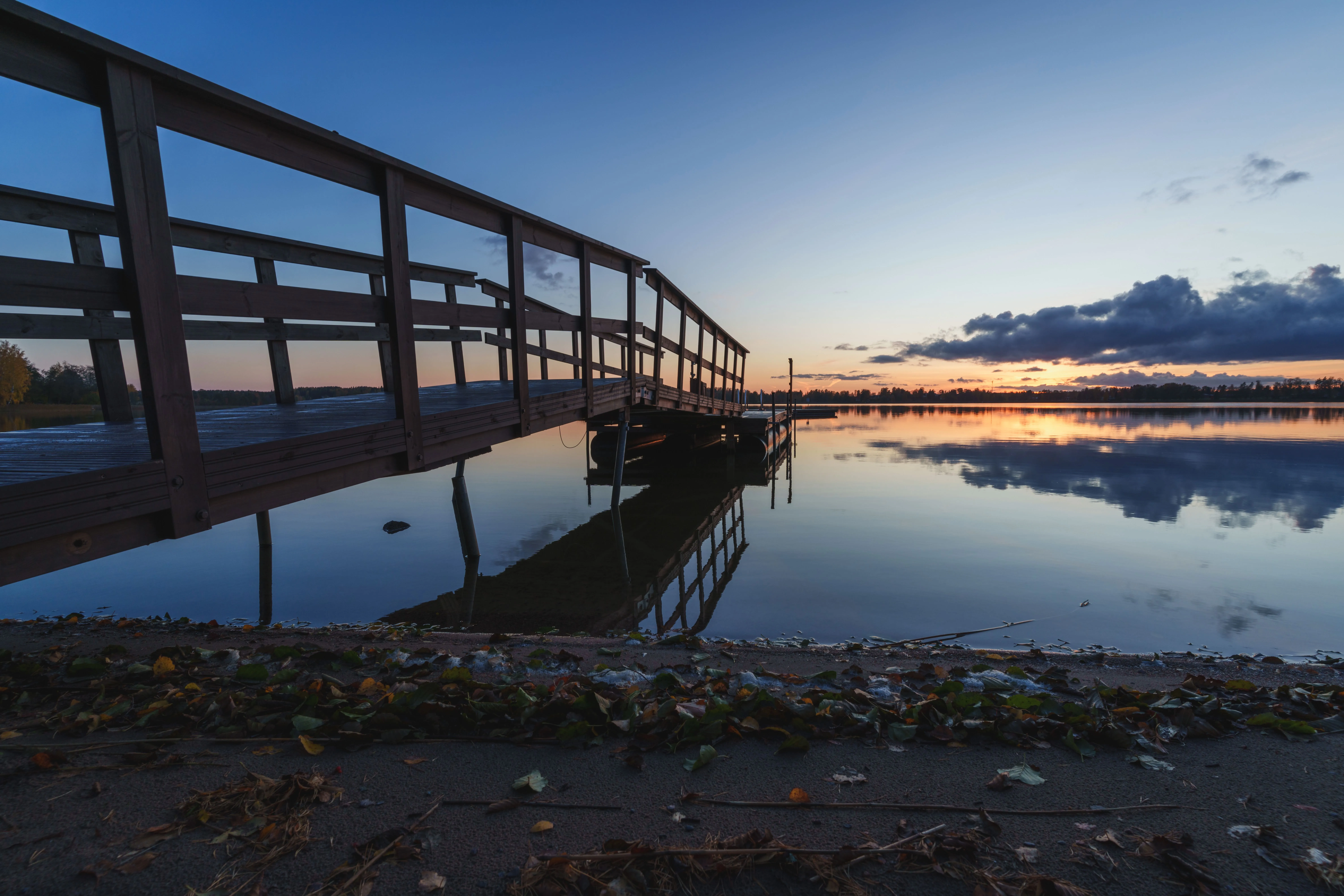 Stillness settling over a lake, showcasing the mirror-calm conditions PhotoWeather helps photographers capture