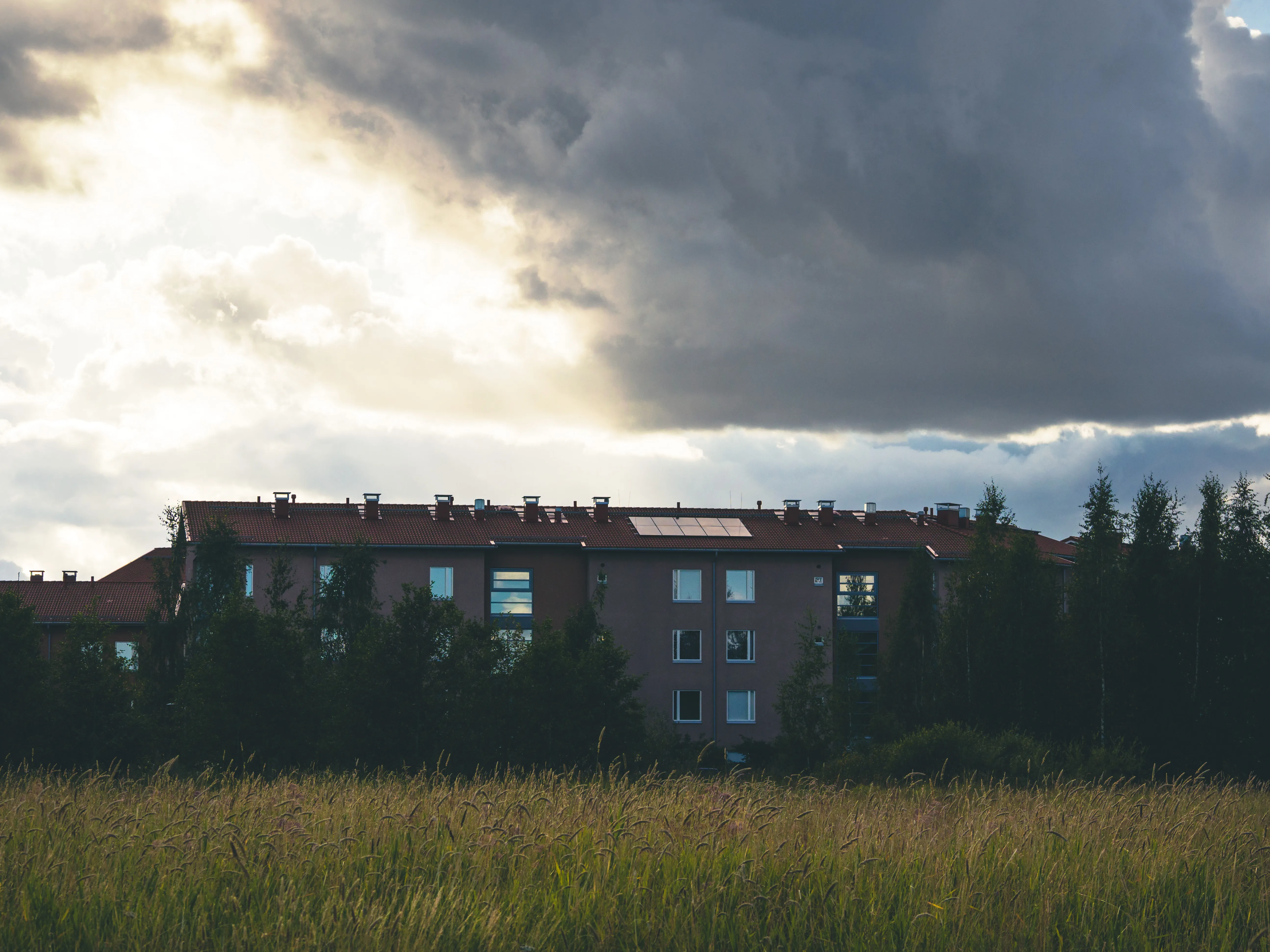 Dramatic clouds over a landscape with golden light breaking through, showcasing the atmospheric conditions PhotoWeather helps photographers capture
