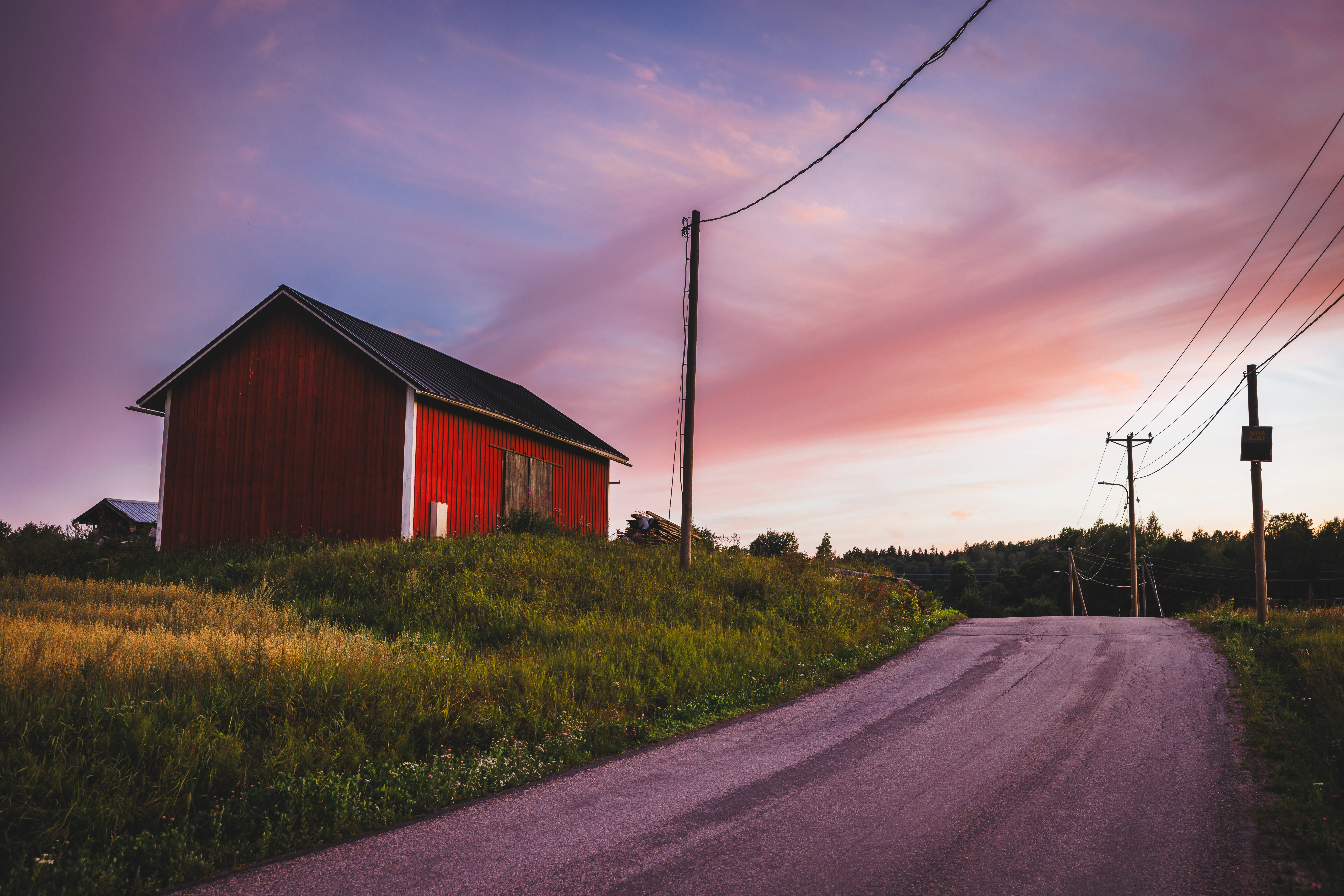 Barn in a field under dramatic sky