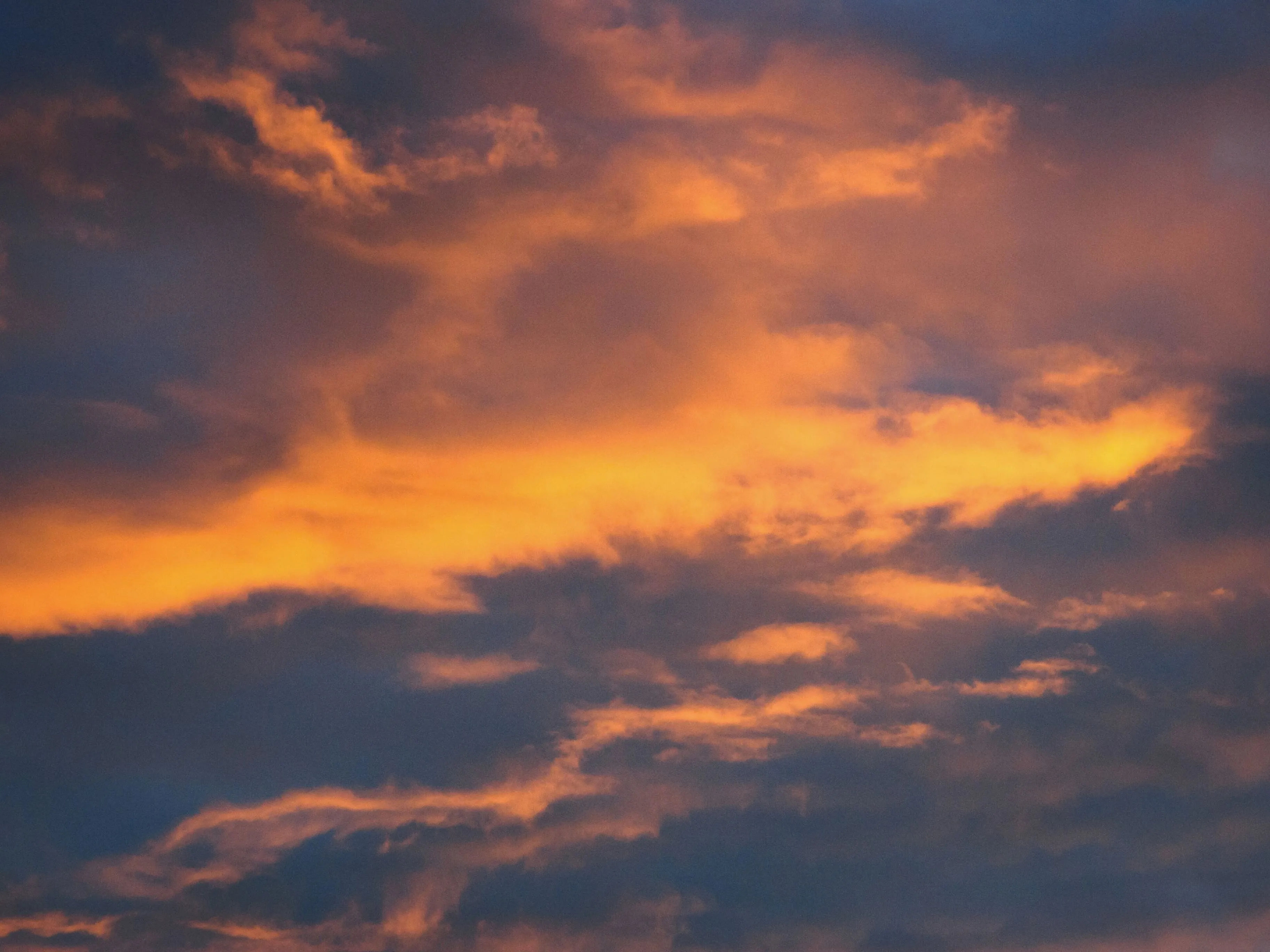Dramatic fiery clouds catching red and orange light